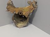 a sculpture of a bird on a shelf in a corner