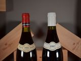 two bottles of wine sitting next to each other on a table