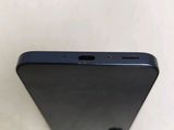 the back of a black cell phone sitting on top of a white table