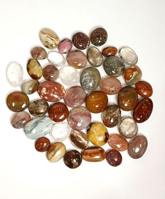 a lot of different colored stones on a white surface
