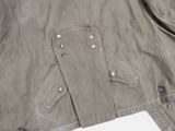 the jacket is green and has buttons on the front