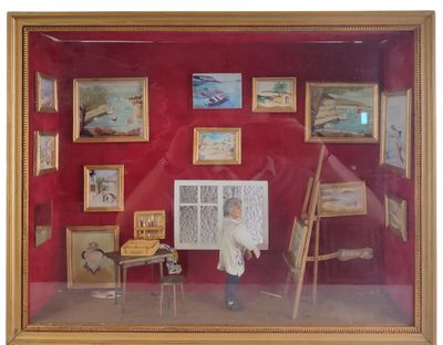 a picture of a man standing in front of a display of paintings