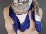 blue and white scarf with a design of a dragon on it