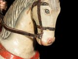 a statue of a man riding a horse on a black background