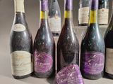 several bottles of wine are lined up on a table