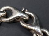 a close up of a metal chain on a black surface