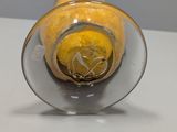 a glass vase with a lemon inside of it on a table