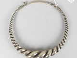 a close up of a silver bracelet on a white surface