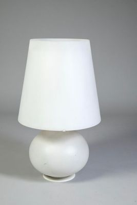 a white table lamp with a white shade on it