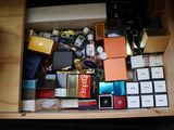 a drawer full of assorted perfumes and beauty products