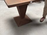 the man is standing next to the table in the shop
