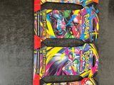 a group of four pokemon trading cards on a table