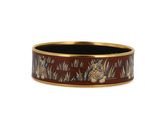 a close up of a brown and gold bracelet with flowers on it