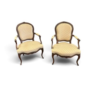 a pair of antique chairs with upholstered upholstered arms