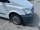 a silver van that is parked in a parking lot