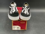pair of black and white vans sneakers sitting on top of a box