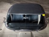 a car that is parked in a garage with its roof down