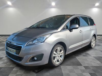 the small silver car is parked in the room on a checkered floor