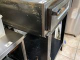 a stove that is in the middle of a kitchen