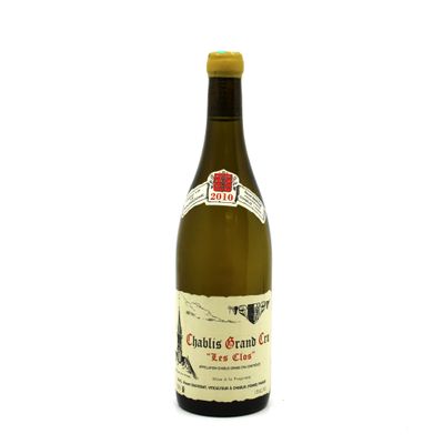 the bottle of white wine is sitting on a white surface