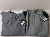 two jackets with tags on them sitting next to each other