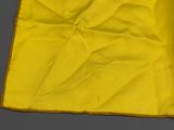 an image of a yellow handkerchief on a gray surface