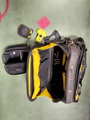un sac jaune et noir posé par terre à côté d'une paire de chaussures