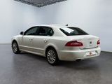 the back of a white volkswagen passat parked in a white room