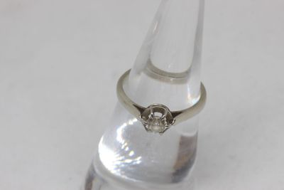 a ring that is sitting on top of a clear glass