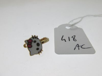 un pin's Hello Kitty muni d'une étiquette