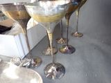 four wine glasses sitting next to each other on a table