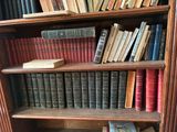 many books that are on a book shelf in the room