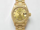 une photo d'une montre Rolex en or avec des diamants sur le cadran