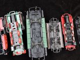 four trains that are lined up on a black surface