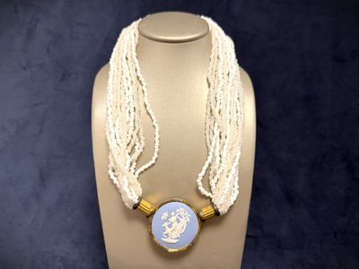 a necklace with a picture on it on a mannequin
