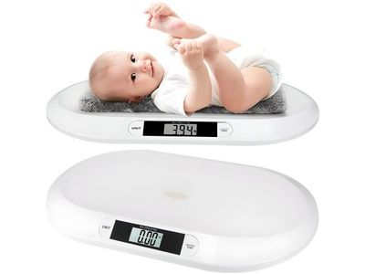 a baby laying on top of a digital scale