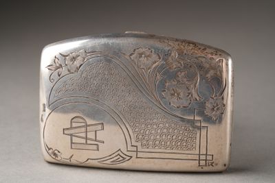 an antique silver cigarette case with a design on the front