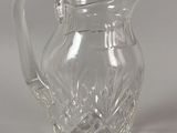 a glass pitcher that is sitting on a table