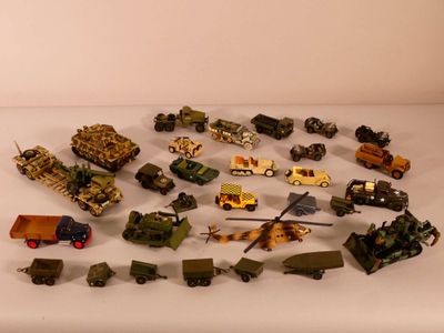 a lot of toy army vehicles on a white table