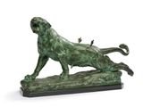 bronze statue of a lion on a rock with a bird on its back