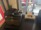 a printer sitting on top of a desk next to a printer