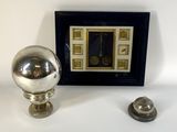 a picture of a silver ball and a picture of a clock on a table