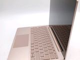 a laptop that is open on a white surface