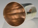 a metal cup that is sitting on a table
