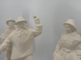 three statues of people that are standing next to each other