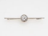 a close up of a tie bar with a diamond on it