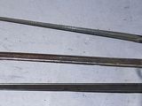 several knives are lined up on a table with a tag on them