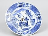 a blue and white plate with a clock on it