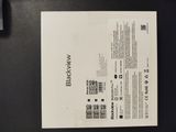 the back of a black and white brochure sitting on top of a table