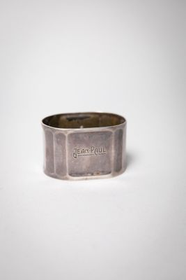 a close up of a silver ring on a white surface